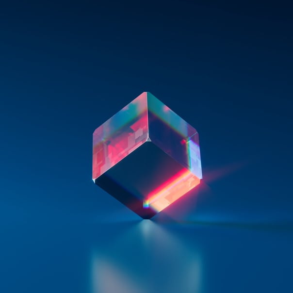 A transparent dice on a blueish background